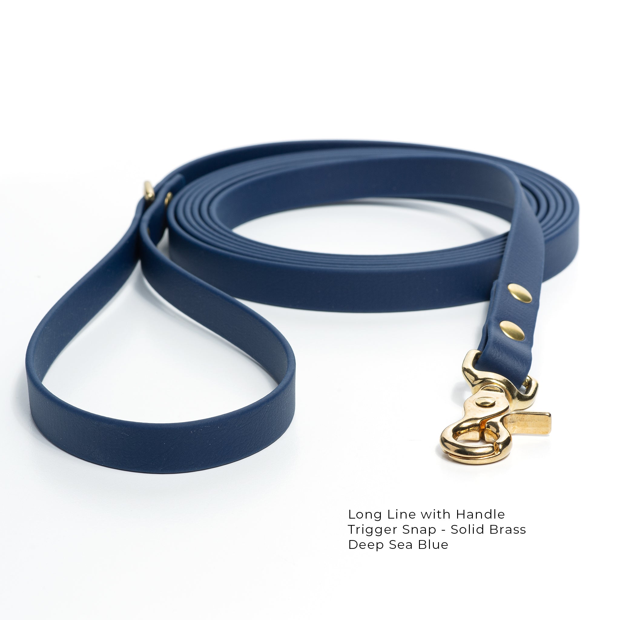 A deep-sea blue biothane lone line with a handle and solid brass trigger snap  coiled on a white background.
