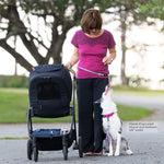 Woman using a biothane hands free leash in mauve and seafoam colors attached to a dog sitting next to her.  Leash is 5/8" width