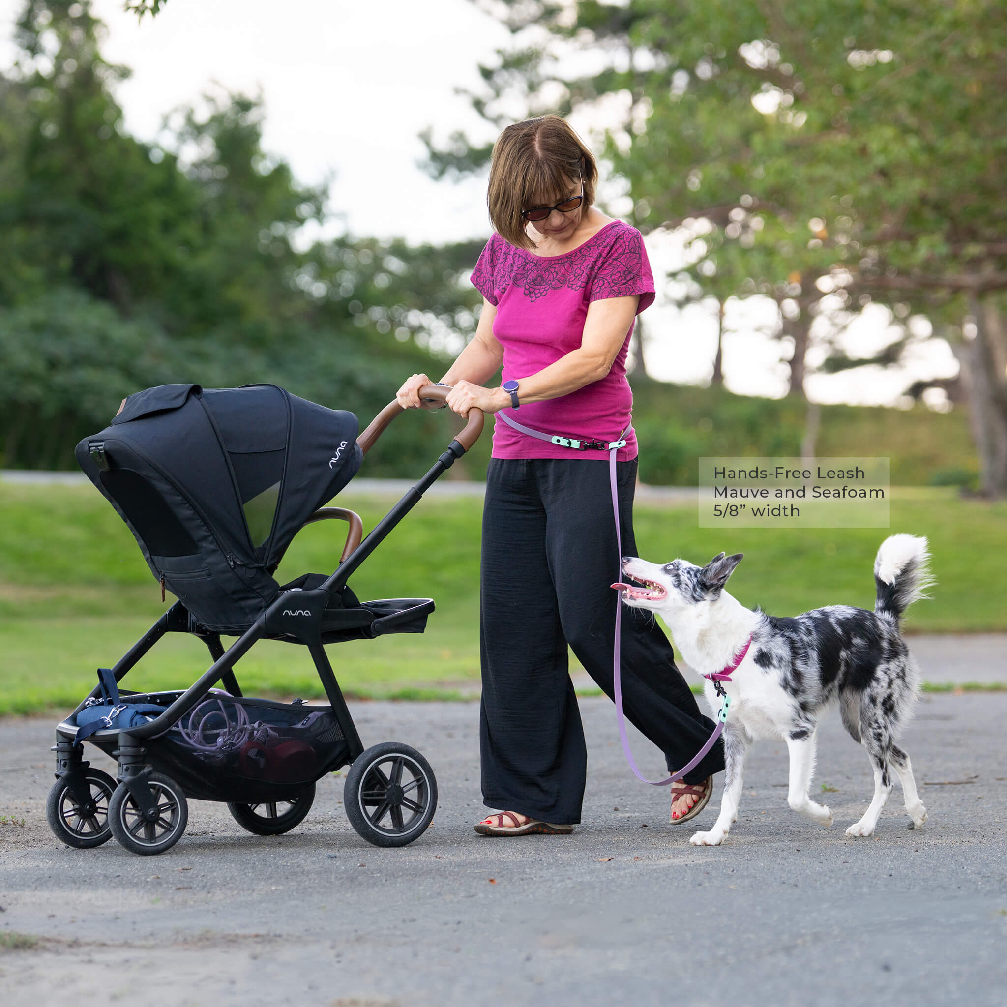 Woman walking a dog using a biothane hands free leash in mauve and seafoam colors.  Leash is 5/8" width