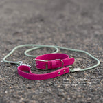 A rolled magenta pink biothane collar and matching sage green biothane rolled leash with silver hardware, placed on a textured gray asphalt surface. White text in the lower right corner reads 'Rolled Leash - Standard Handle - Handle - 3/4 width - Magenta - Leash - Sage.