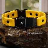 A yellow fi-compatible quick-release dog collar with a matte black buckle and a fi GPS device attached, placed on a rock.